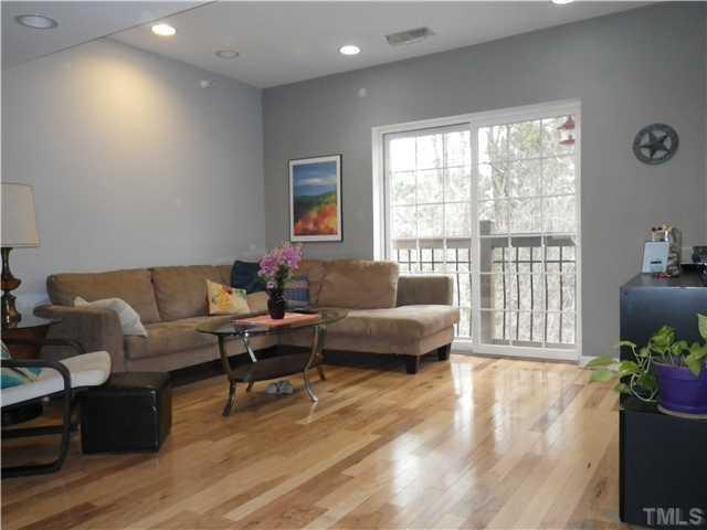 720 Bilyeu Street, Unit 304 Raleigh, NC 27606 - Photo 5 of 10 a living room with furniture and a large window