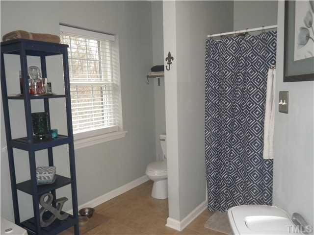 720 Bilyeu Street, Unit 304 Raleigh, NC 27606 - Photo 8 of 10 a bathroom with a toilet and a shower curtain