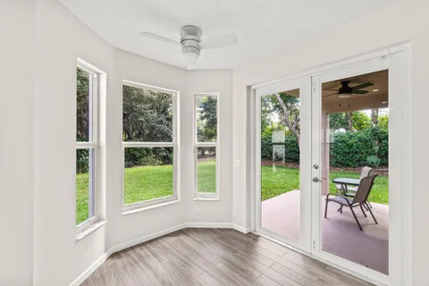 a view of a livingroom with furniture wooden floor and windows
