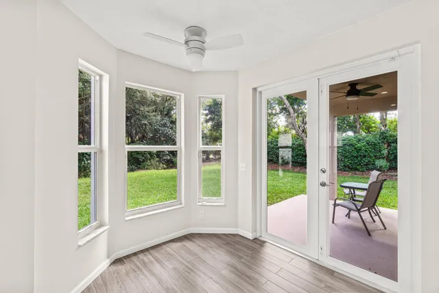 a view of a livingroom with furniture wooden floor and windows