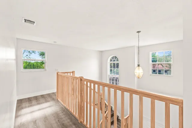 a view of a hallway with windows