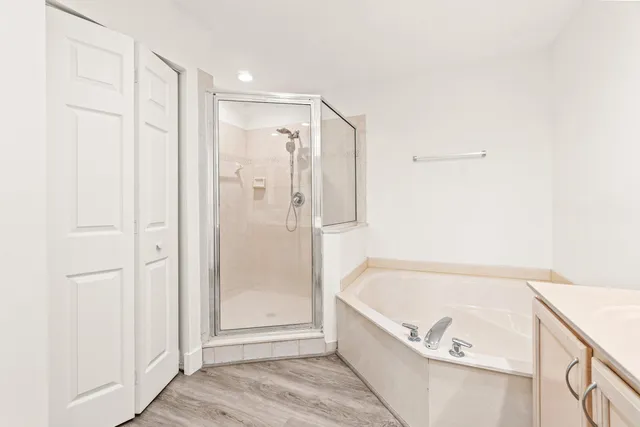 a bathroom with a tub shower and hallway