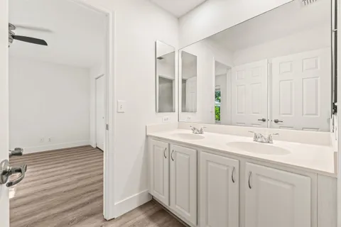 a bathroom with 2 sink and a mirror