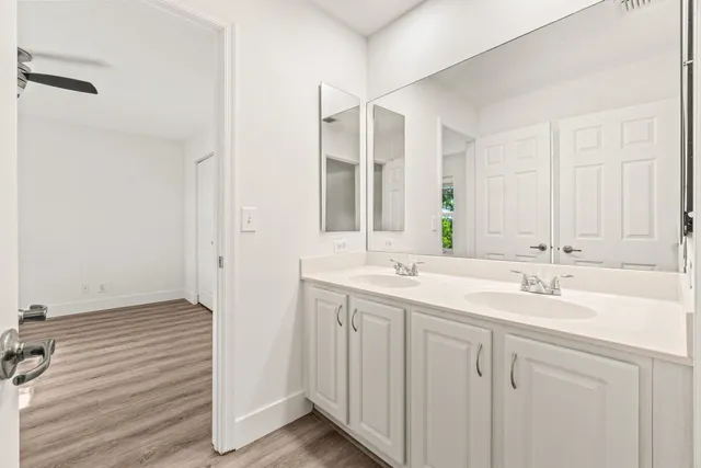 a bathroom with 2 sink and a mirror