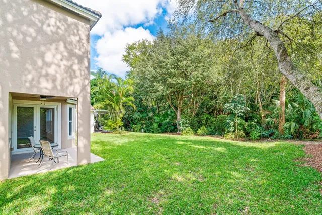 a view of a house with a yard and sitting area
