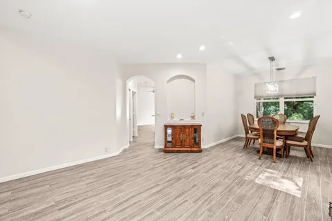 a view of a dining room with furniture and wooden floor