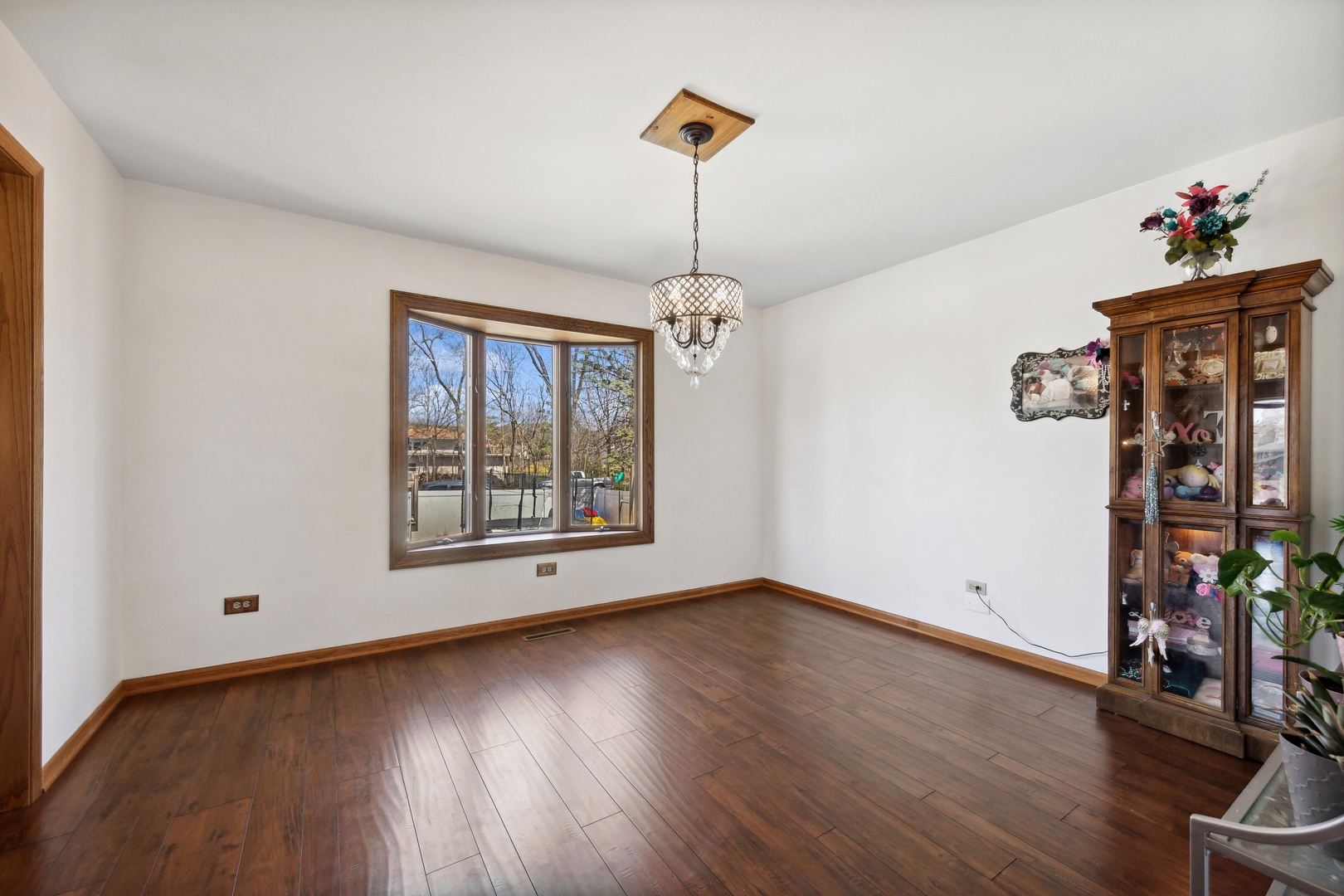 1040 North Cedar Road New Lenox, IL 60451 - Photo 8 of 37 a view of livingroom with wooden floor and a window