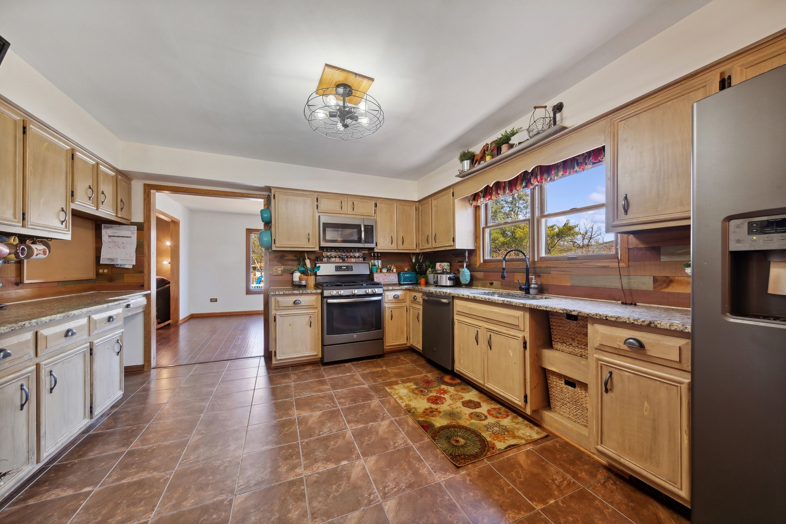 1040 North Cedar Road New Lenox, IL 60451 - Photo 10 of 37 a kitchen with stainless steel appliances and chandelier