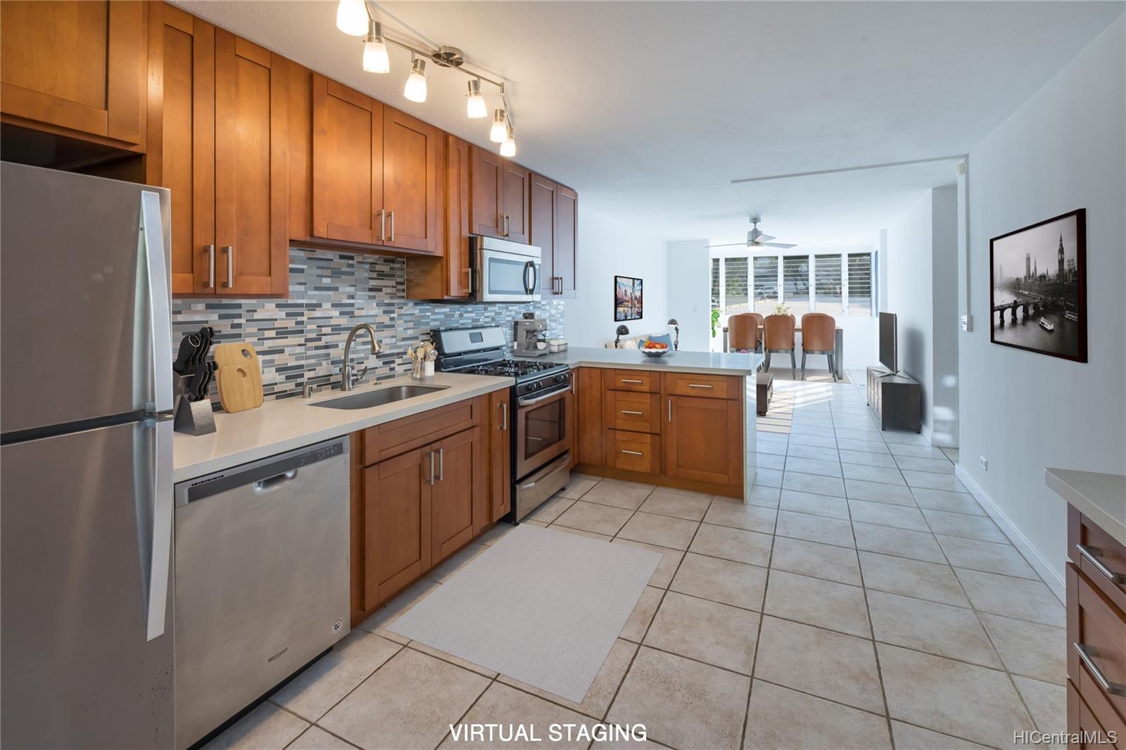 a kitchen with stainless steel appliances granite countertop a refrigerator stove top oven a sink dishwasher and a refrigerator with wooden cabinets