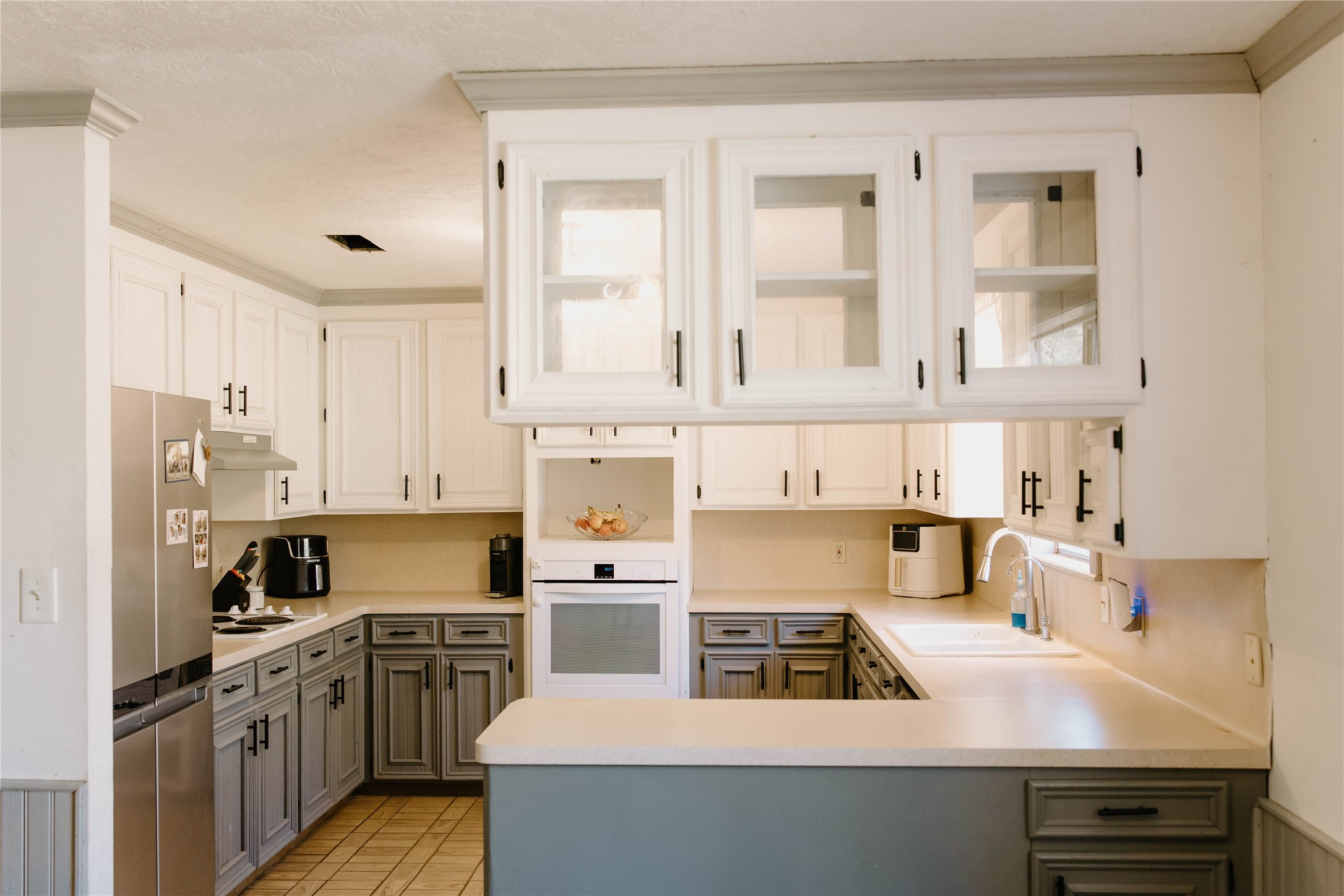 16120 Hartman Road Magnolia, TX 77355 - Photo 11 of 41 a kitchen with stainless steel appliances a stove a sink and white cabinets