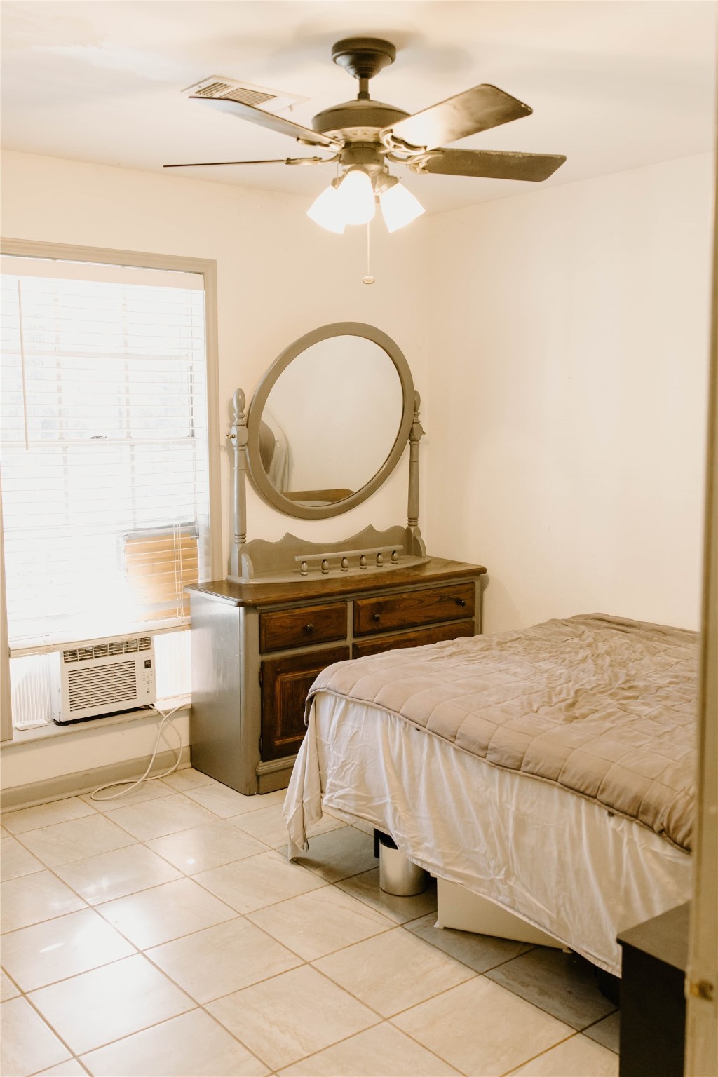 16120 Hartman Road Magnolia, TX 77355 - Photo 24 of 41 a bedroom with a bed and a chandelier