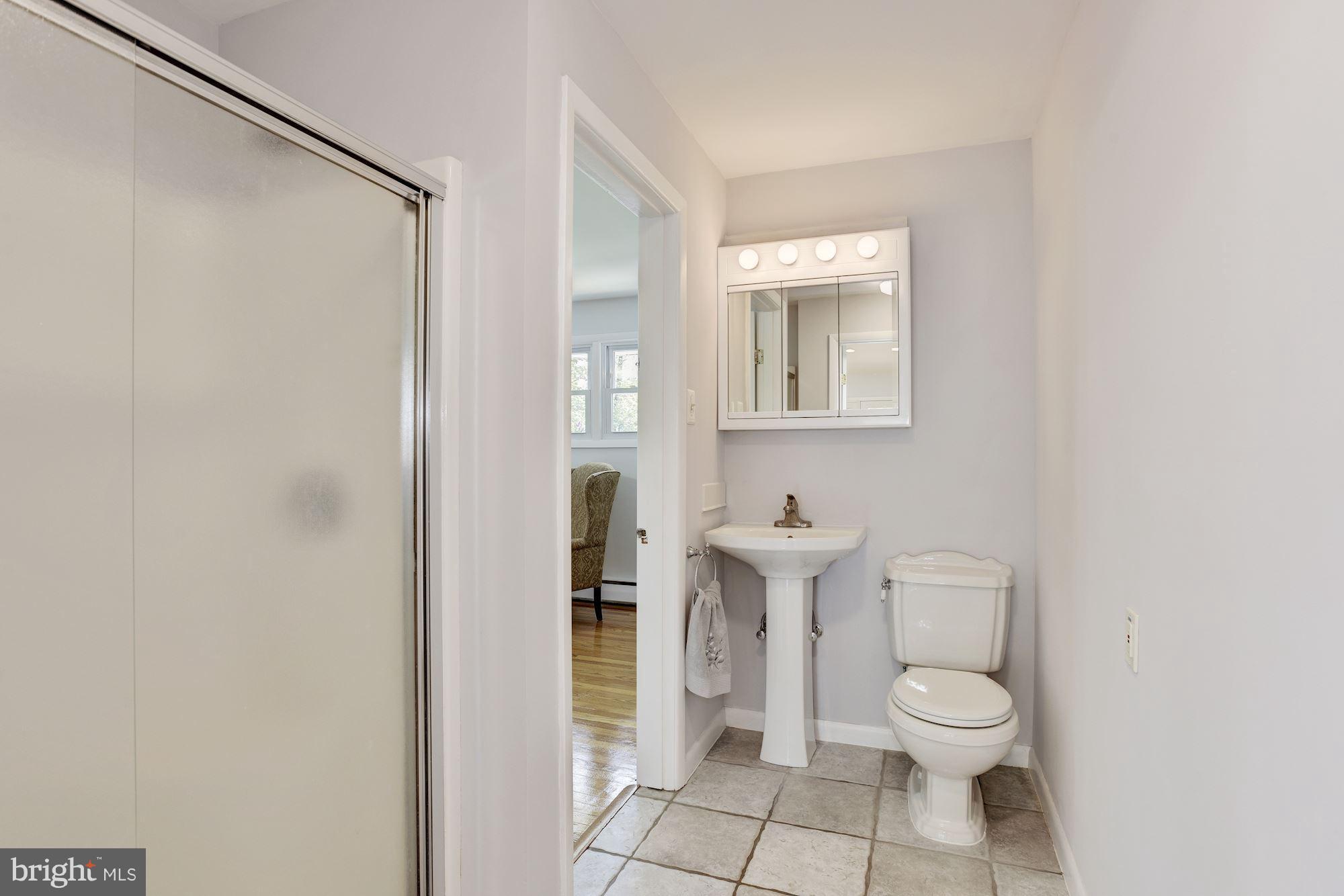 3618 Macalpine Road Ellicott City, MD 21042 - Photo 15 of 30 a bathroom with a toilet a sink and shower