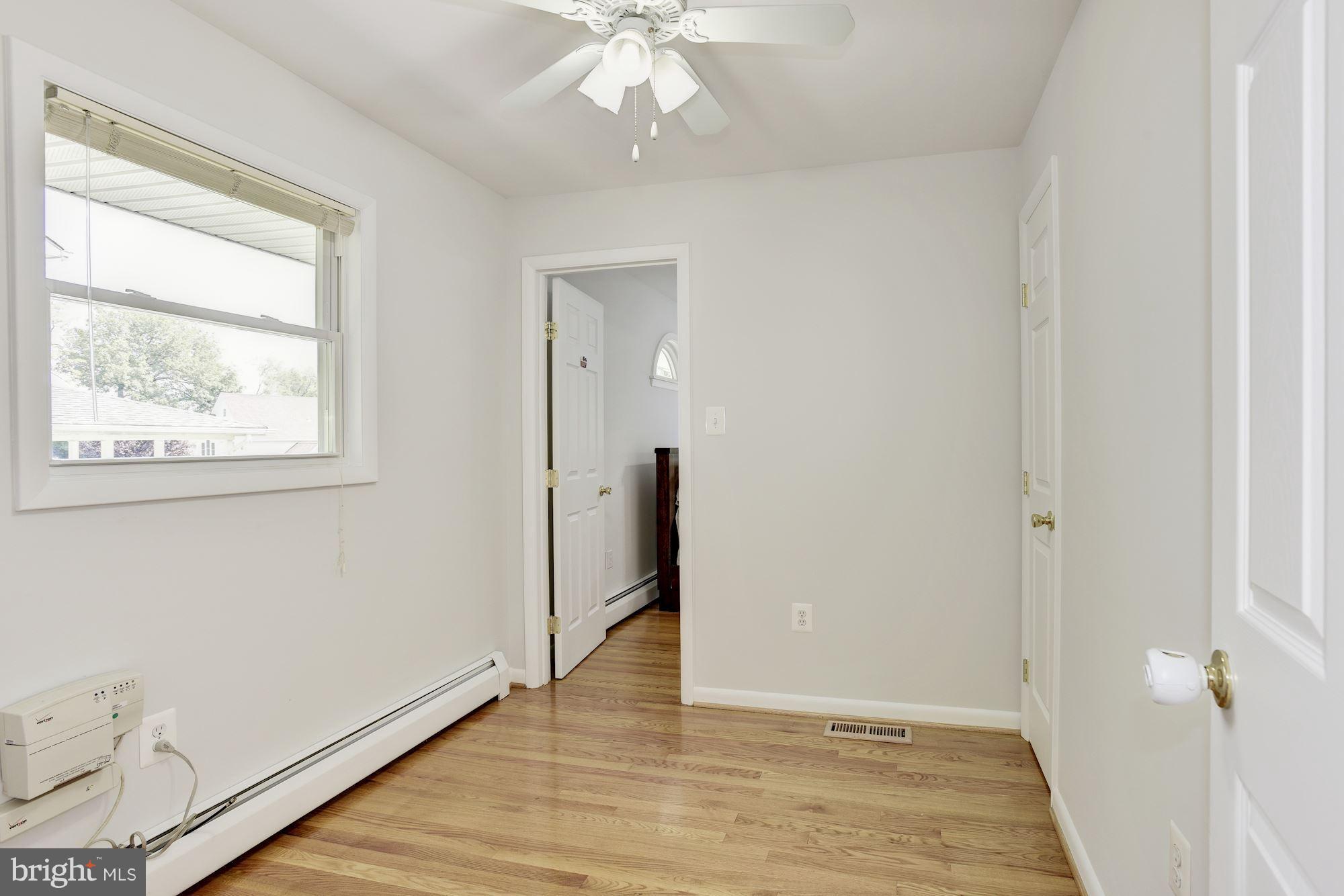 3618 Macalpine Road Ellicott City, MD 21042 - Photo 16 of 30 an empty room with wooden floor and a window