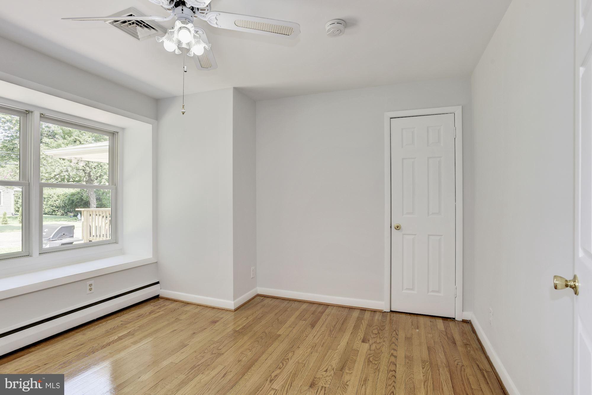 3618 Macalpine Road Ellicott City, MD 21042 - Photo 17 of 30 a view of an empty room with a window and wooden floor