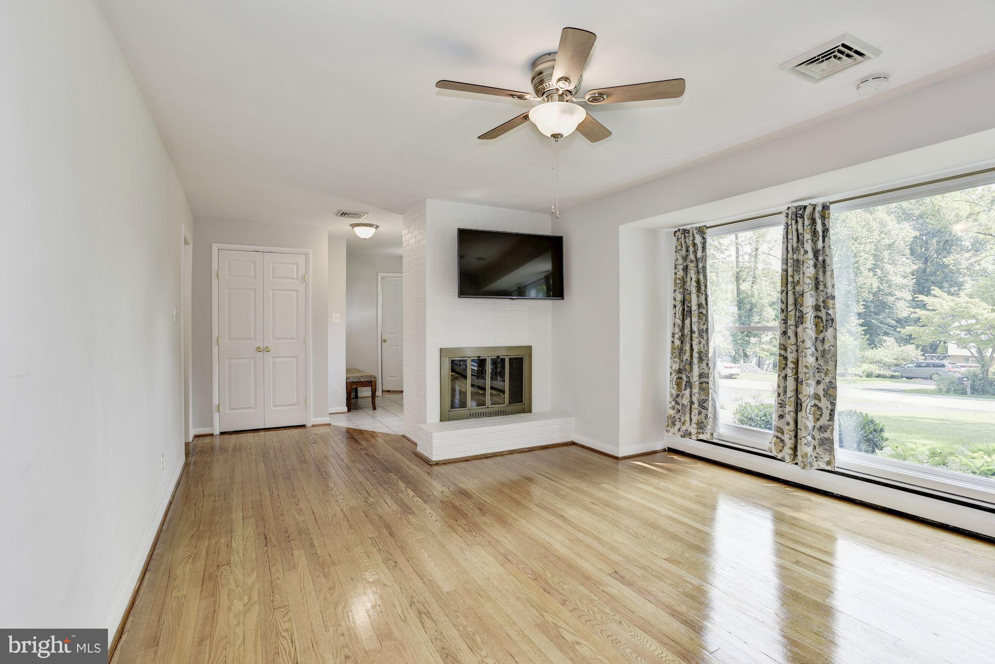 3618 Macalpine Road Ellicott City, MD 21042 - Photo 4 of 30 a view of an empty room with a fireplace and a window