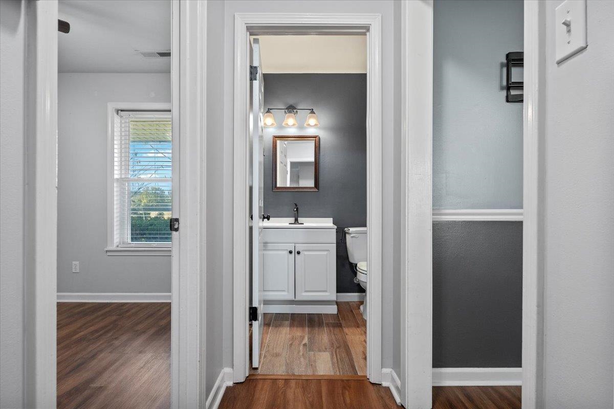 9496 Holly Grove Road Brighton, TN 38011 - Photo 21 of 29 Bathroom featuring vanity and dark wood-style flooring