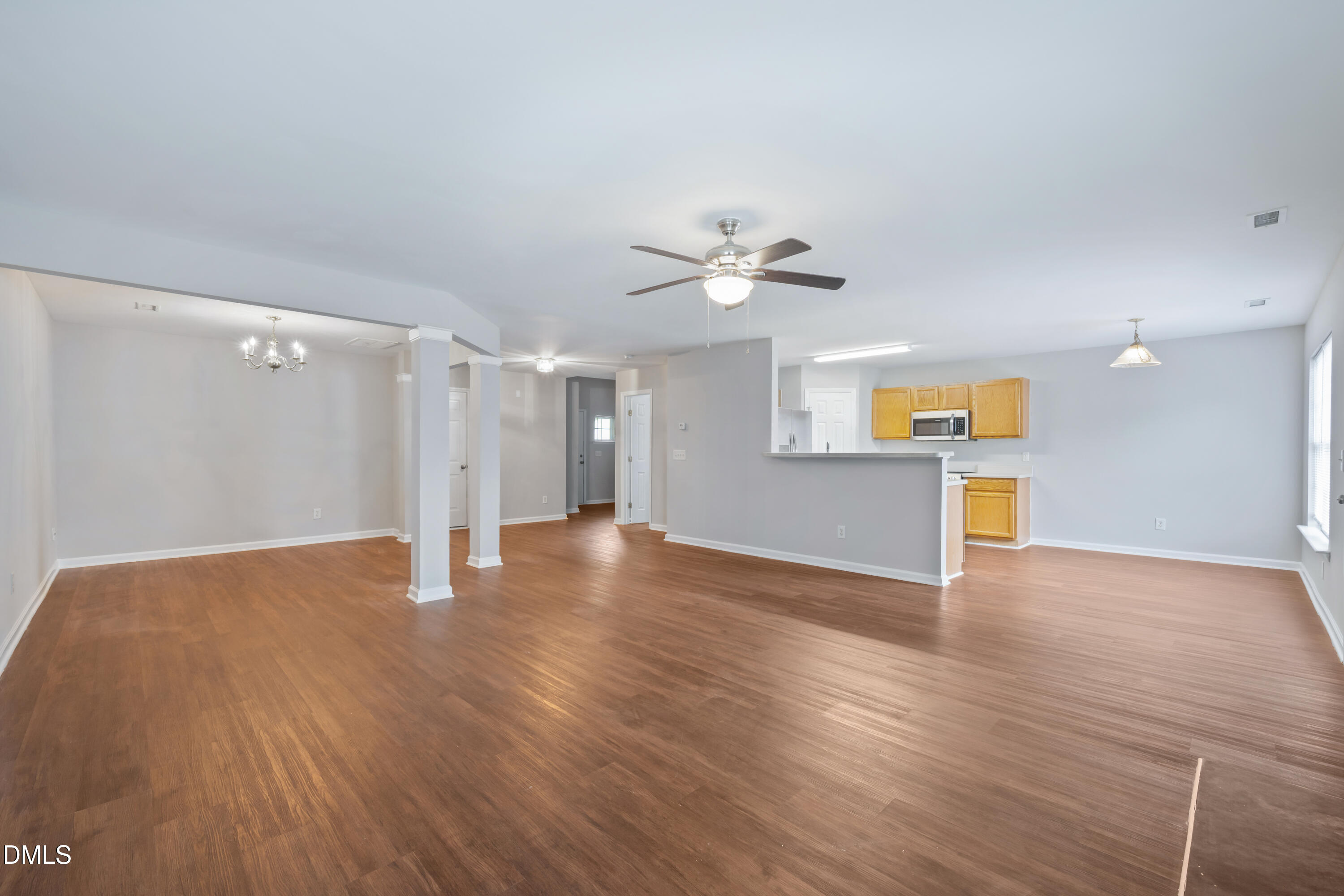 1532 Pebble Ridge Drive Raleigh, NC 27610 - Photo 12 of 40 a view of a kitchen with wooden floor and a ceiling fan