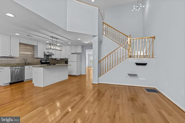 a view of kitchen with wooden floor and electronic appliances