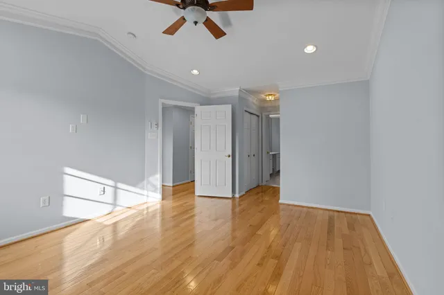 a view of empty room with wooden floor