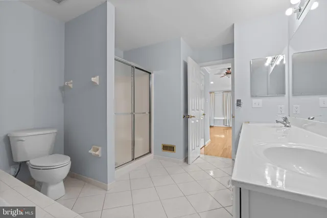 a spacious bathroom with a bathtub shower sink mirror and toilet