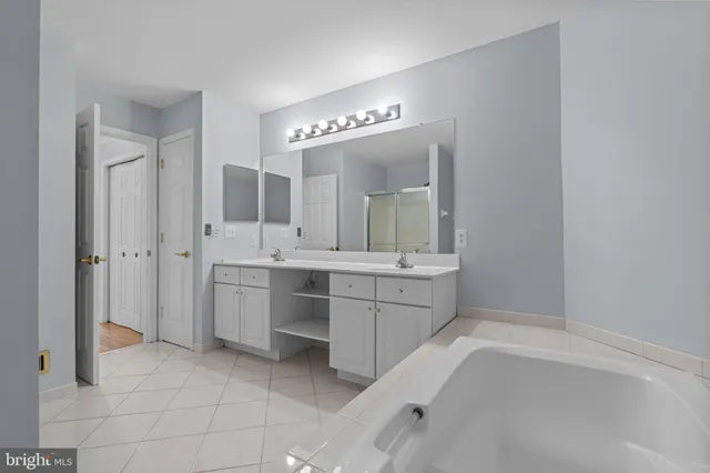 a bathroom with a sink a vanity and a mirror