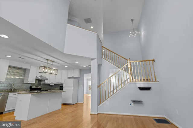 a kitchen with stainless steel appliances kitchen island sink refrigerator and stove