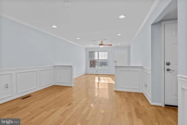a view of empty room with wooden floor