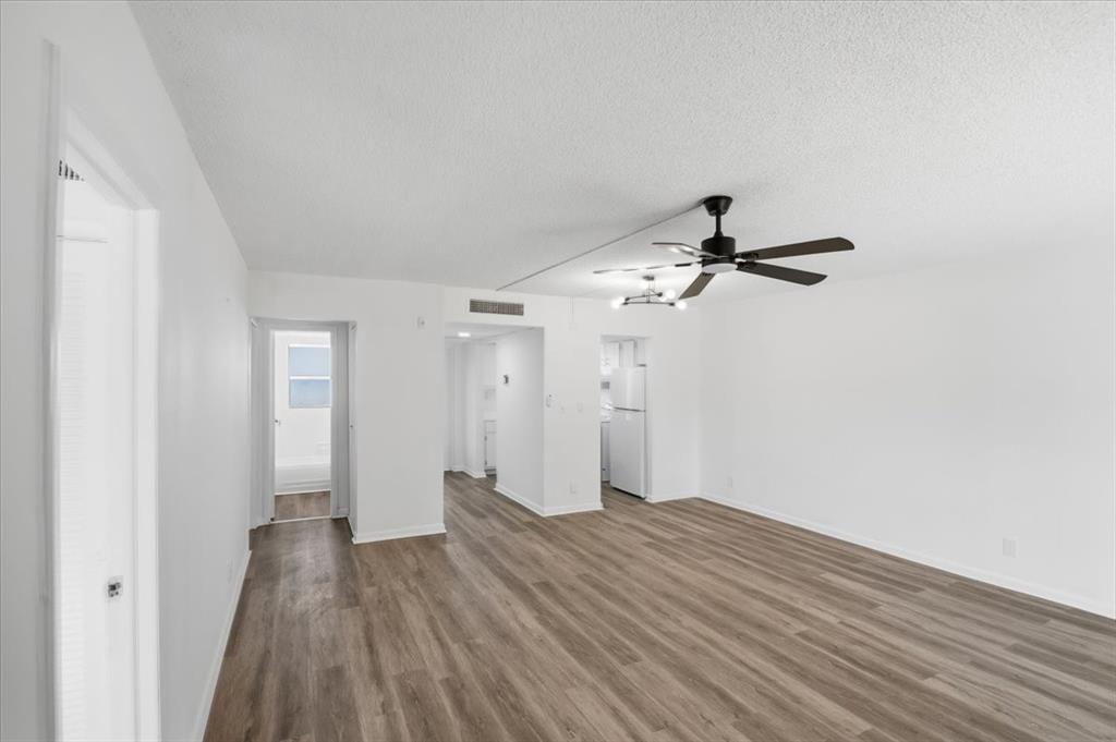 4161 Northwest 26th Street, Unit 105 Lauderhill, FL 33313 - Photo 17 of 26 a view of a room with wooden floor ceiling fan and window