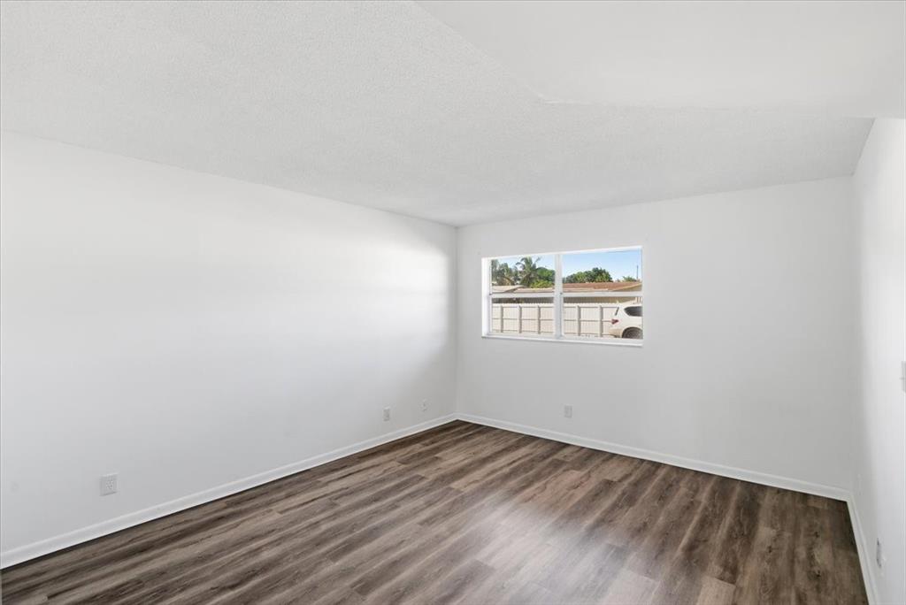 4161 Northwest 26th Street, Unit 105 Lauderhill, FL 33313 - Photo 19 of 26 a view of a room that has wooden floor and window
