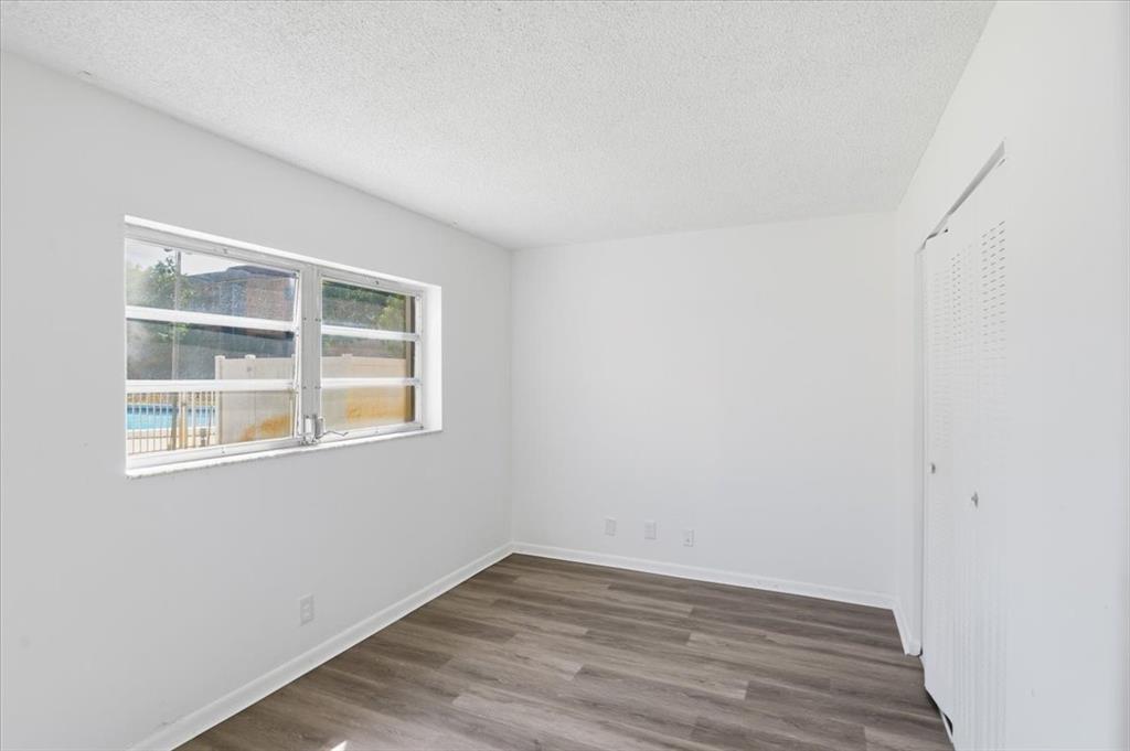 4161 Northwest 26th Street, Unit 105 Lauderhill, FL 33313 - Photo 21 of 26 an empty room with wooden floor and windows