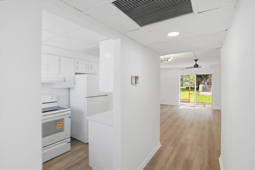 4161 Northwest 26th Street, Unit 105 Lauderhill, FL 33313 - Photo 6 of 26 a kitchen with white cabinets and white appliances