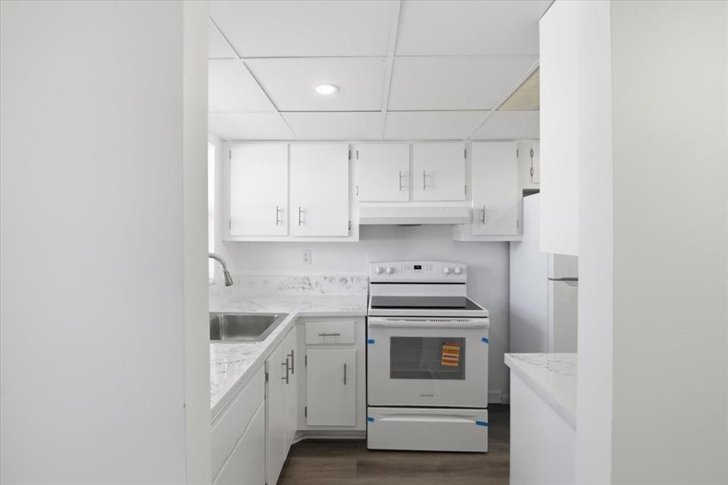 4161 Northwest 26th Street, Unit 105 Lauderhill, FL 33313 - Photo 8 of 26 a kitchen with white cabinets and white appliances