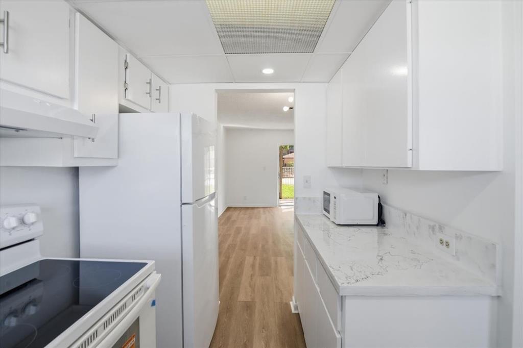 4161 Northwest 26th Street, Unit 105 Lauderhill, FL 33313 - Photo 10 of 26 a hallway with a sink and cabinets