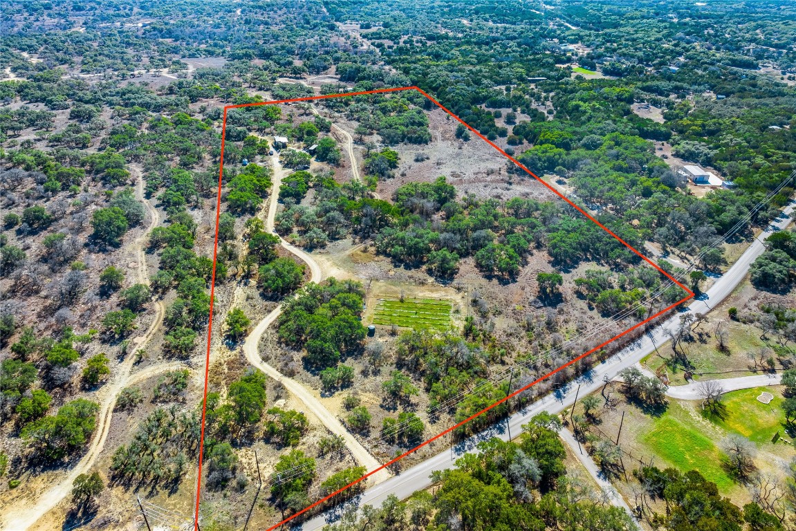 an aerial view of residential houses with outdoor space and street view