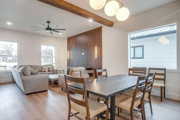 a view of a dining room with furniture and wooden floor