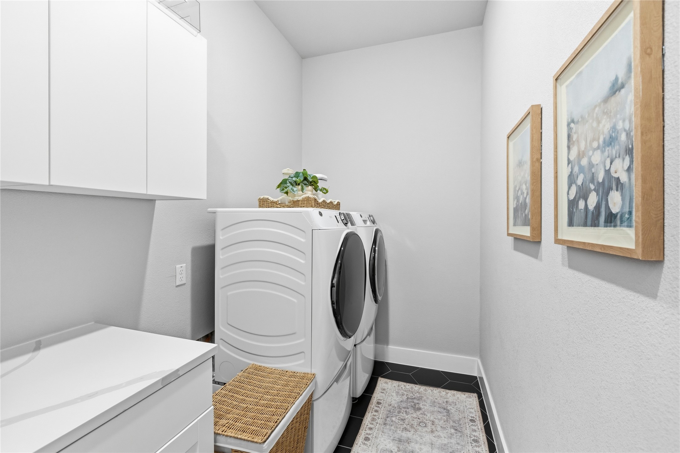 836 Villa Rialto View Leander, TX 78641 - Photo 22 of 33 Ample storage and modern appliances elevate everyday chores in this well-appointed laundry space.