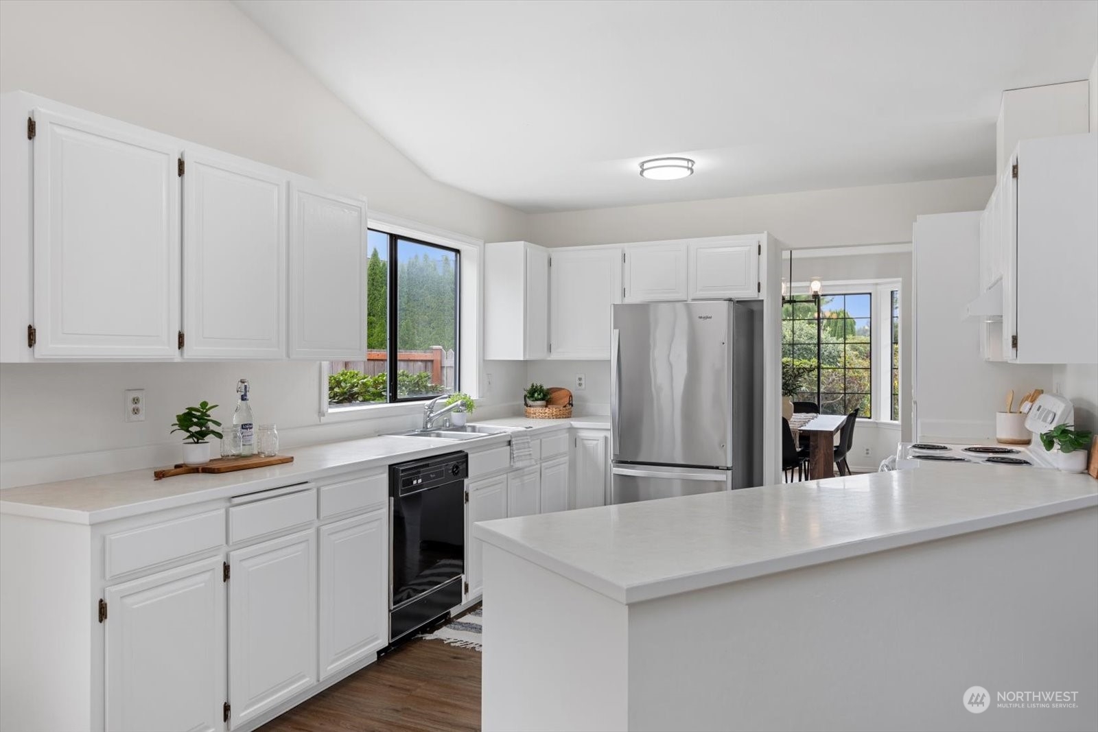 2480 215th Place Southwest Brier, WA 98036 - Photo 21 of 40 a kitchen with white cabinets and white appliances