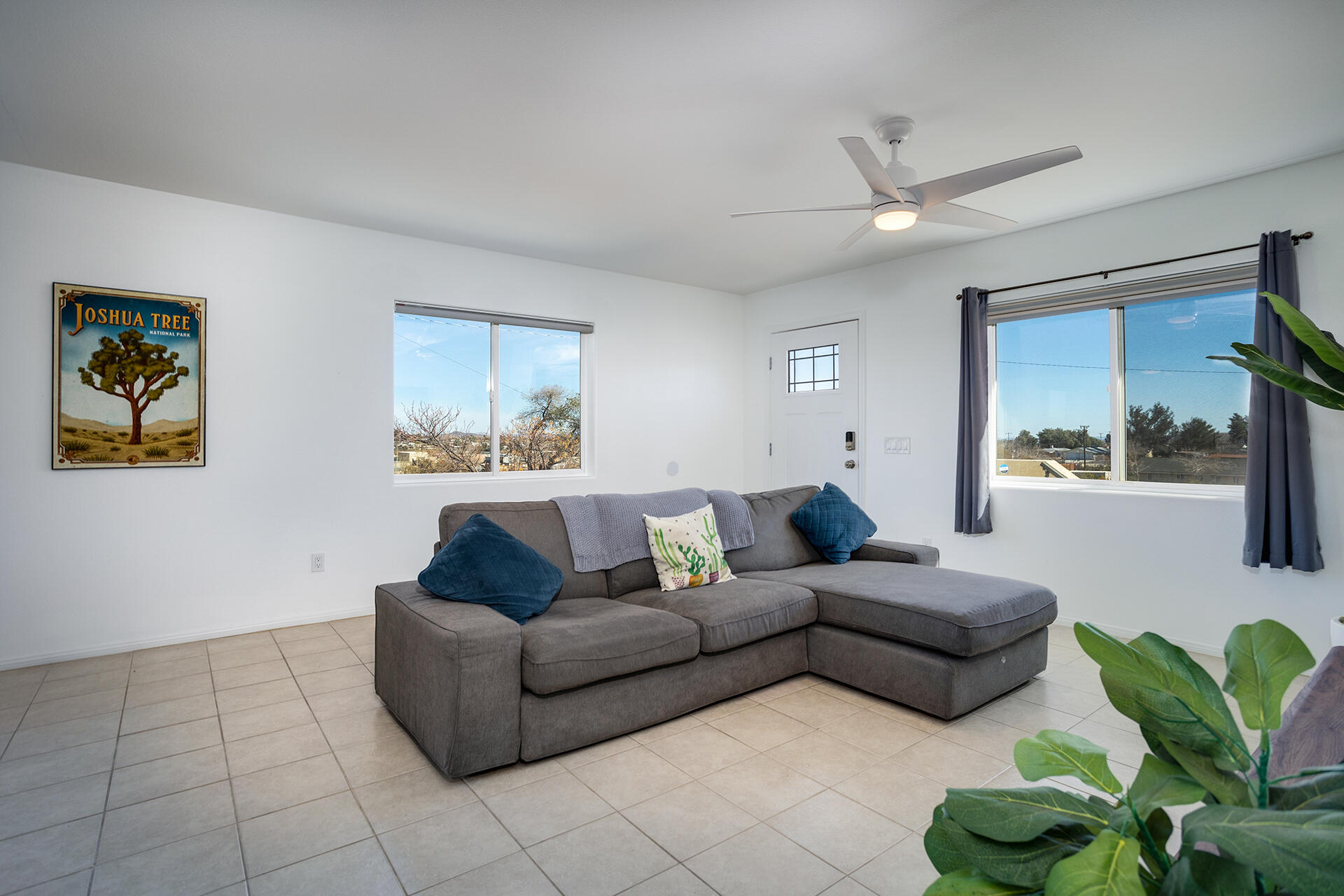 61786 Desert Air Road Joshua Tree, CA 92252 - Photo 35 of 54 a living room with furniture and a large window