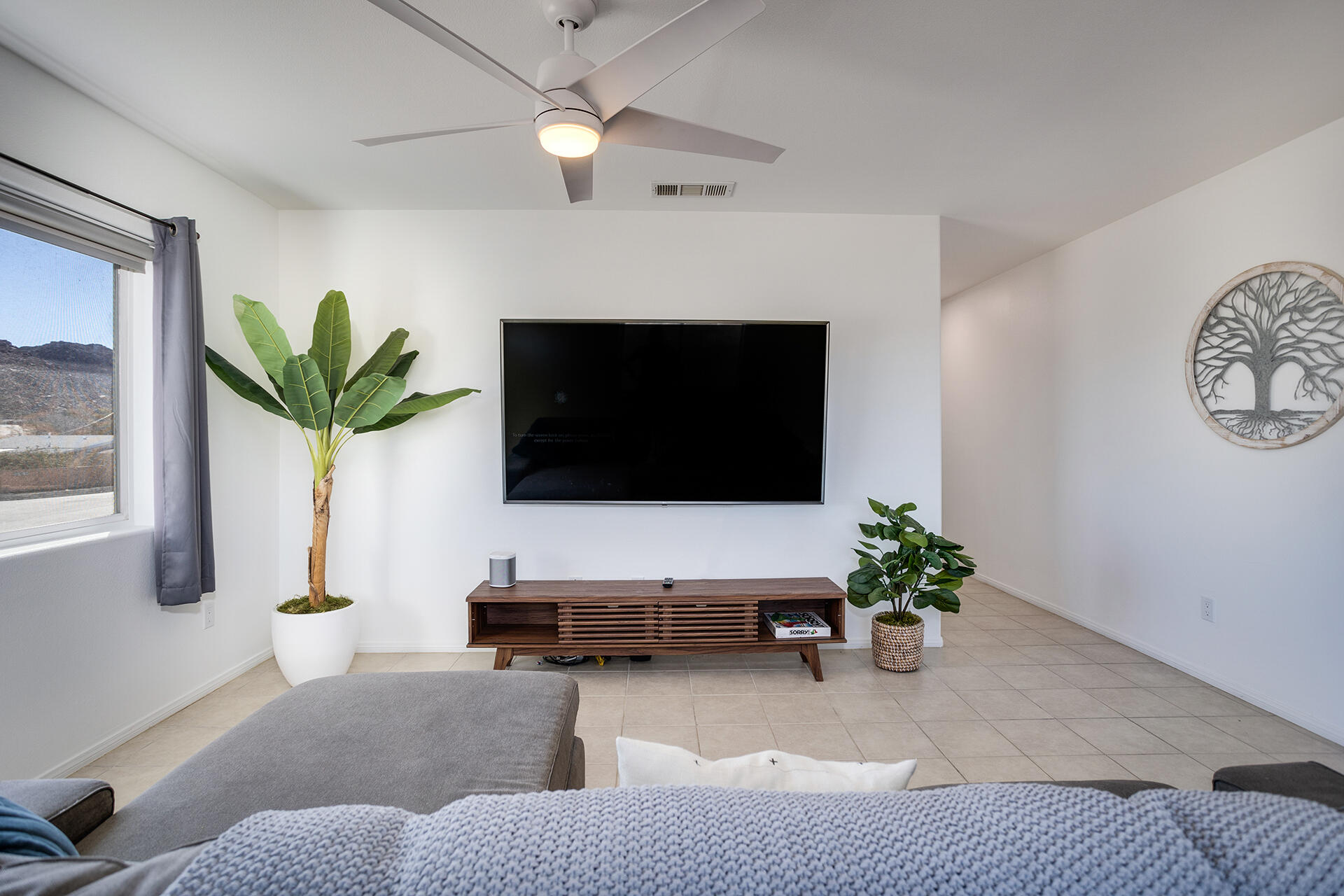 61786 Desert Air Road Joshua Tree, CA 92252 - Photo 36 of 54 a living room with furniture potted plant and a window