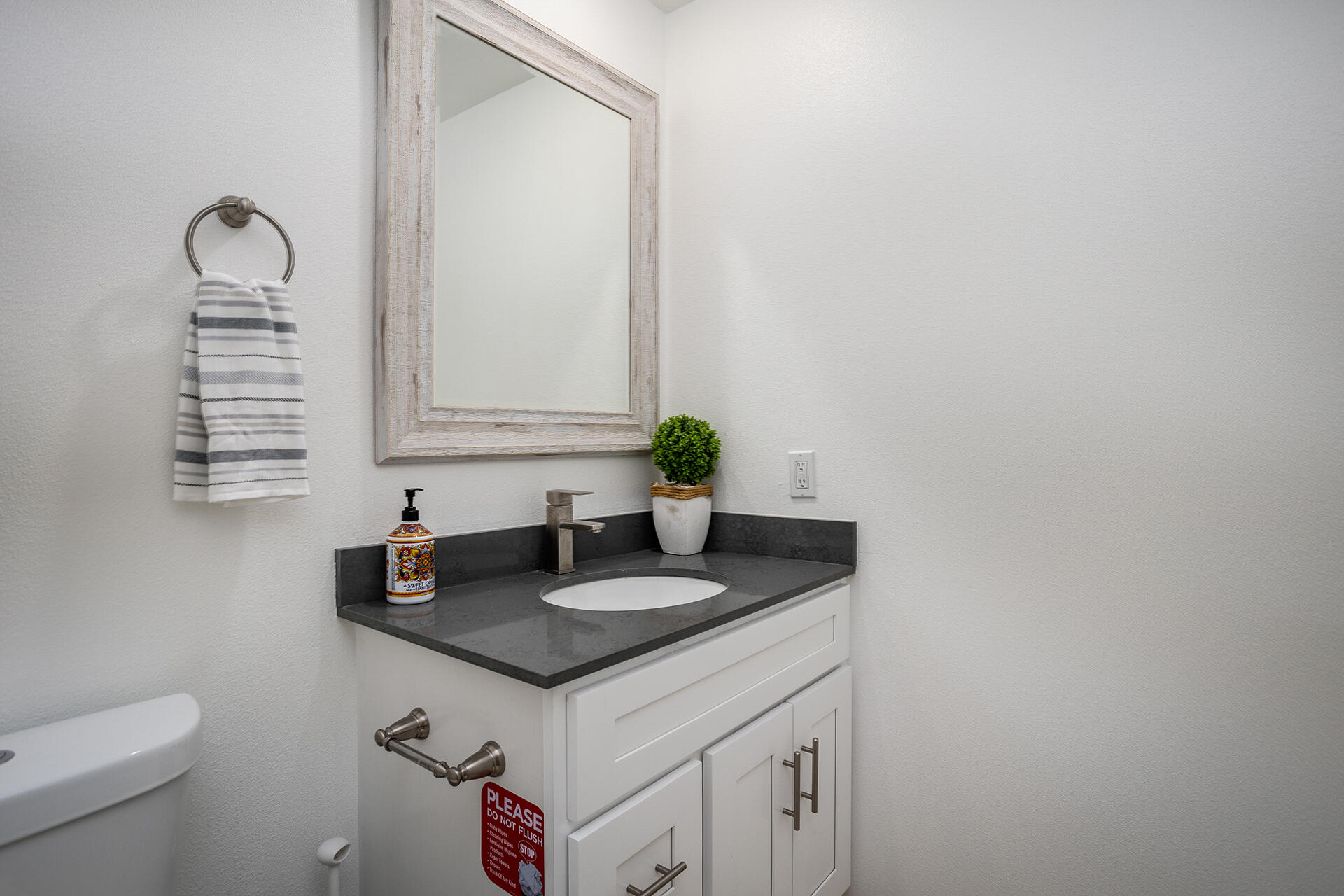 61786 Desert Air Road Joshua Tree, CA 92252 - Photo 42 of 54 a bathroom with a granite countertop sink and a mirror