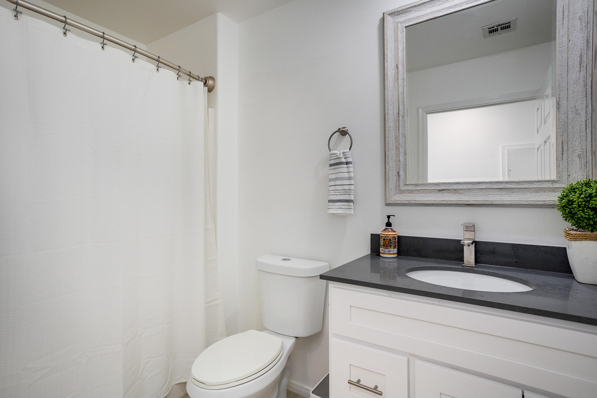 61786 Desert Air Road Joshua Tree, CA 92252 - Photo 43 of 54 a bathroom with a granite countertop sink toilet and a mirror