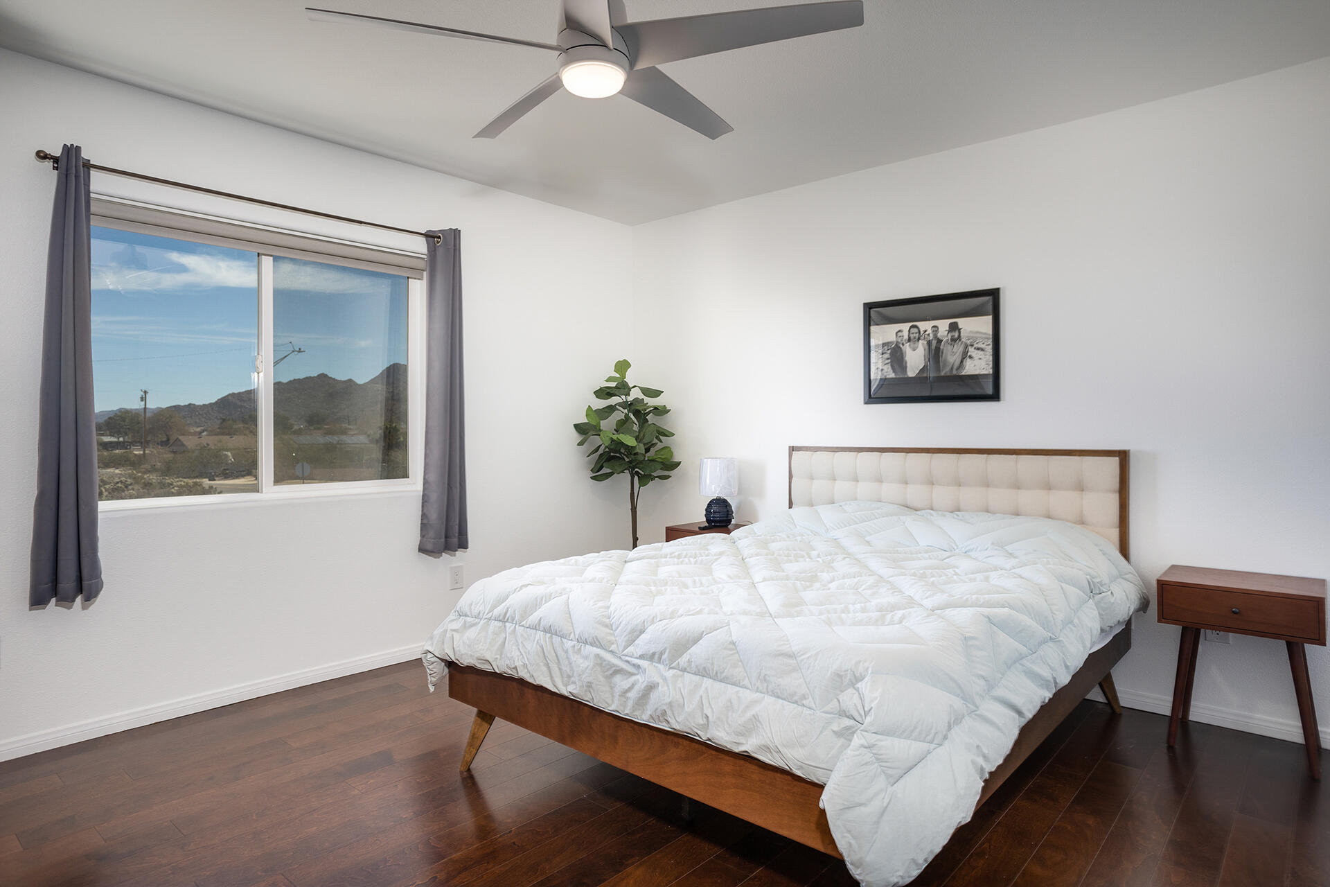 61786 Desert Air Road Joshua Tree, CA 92252 - Photo 45 of 54 a bedroom with a bed wall painting and a window