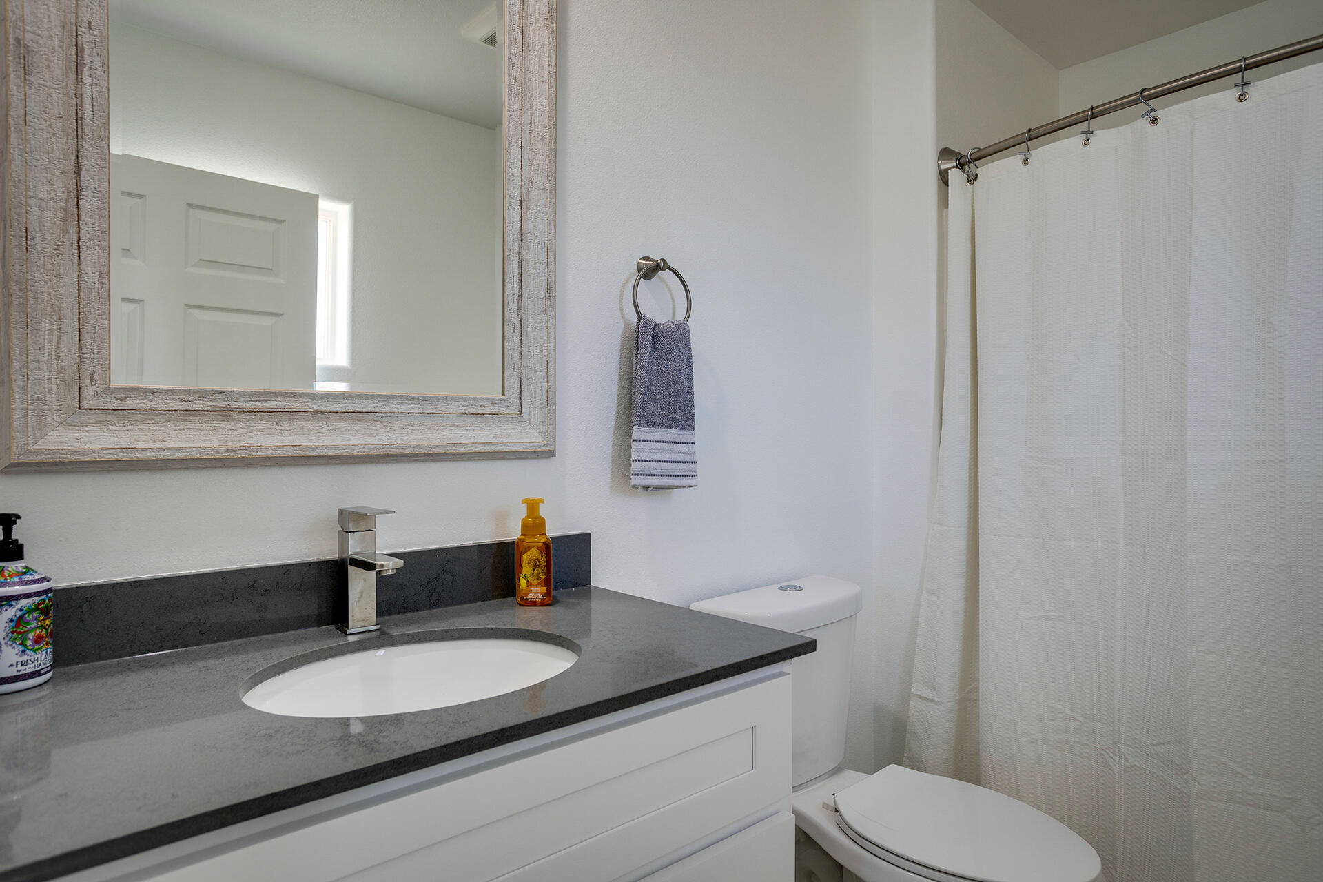 61786 Desert Air Road Joshua Tree, CA 92252 - Photo 47 of 54 a bathroom with a granite countertop toilet sink and mirror