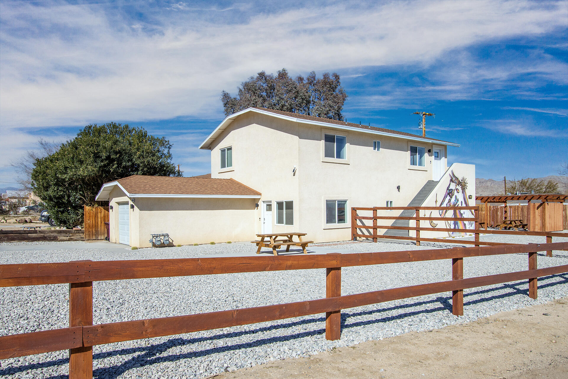 61786 Desert Air Road Joshua Tree, CA 92252 - Photo 8 of 54 a view of house with outdoor space and lots of windows