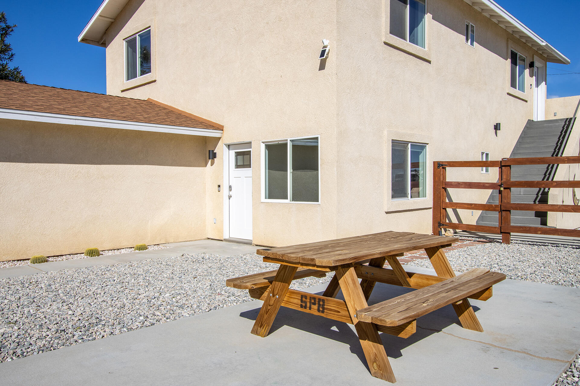 61786 Desert Air Road Joshua Tree, CA 92252 - Photo 9 of 54 a wooden bench sitting in front of a building