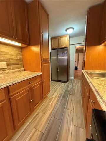 a kitchen with stainless steel appliances a refrigerator and a stove