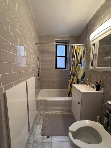 a bathroom with a sink a bathtub and toilet
