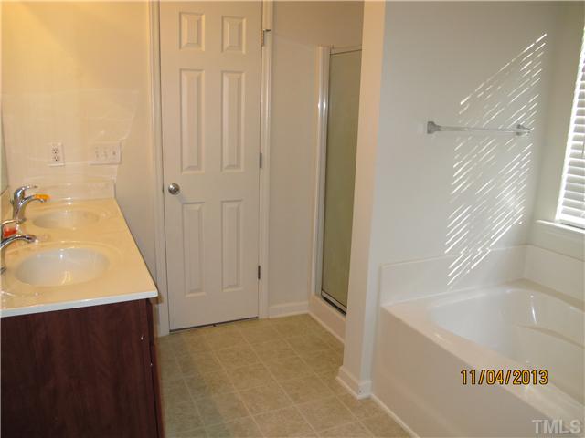5108 Sansome Trail Raleigh, NC 27610 - Photo 7 of 11 a bathroom with a sink and a bathtub