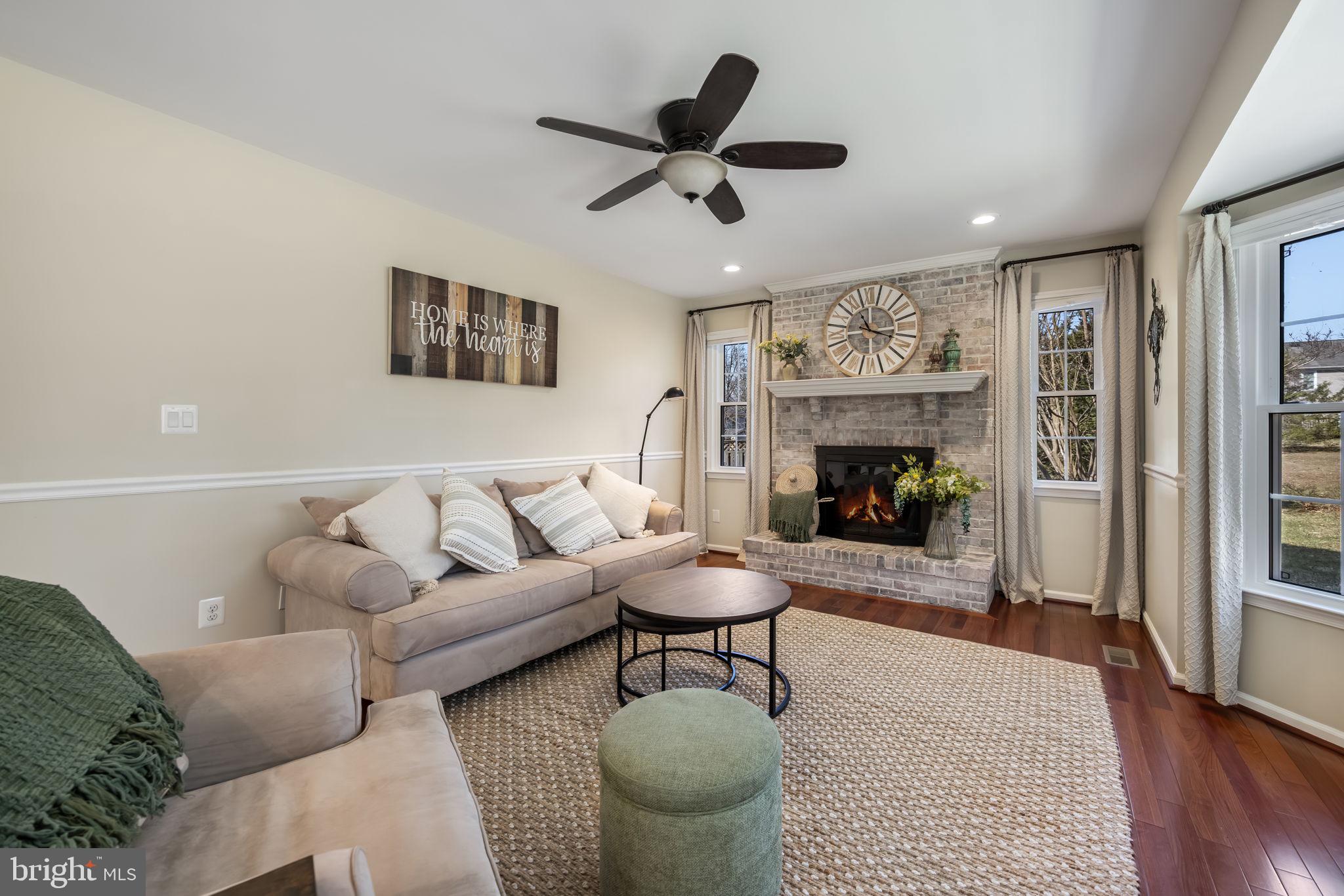 8504 Silverdale Road Lorton, VA 22079 - Photo 18 of 48 a living room with furniture a fireplace and wooden floor