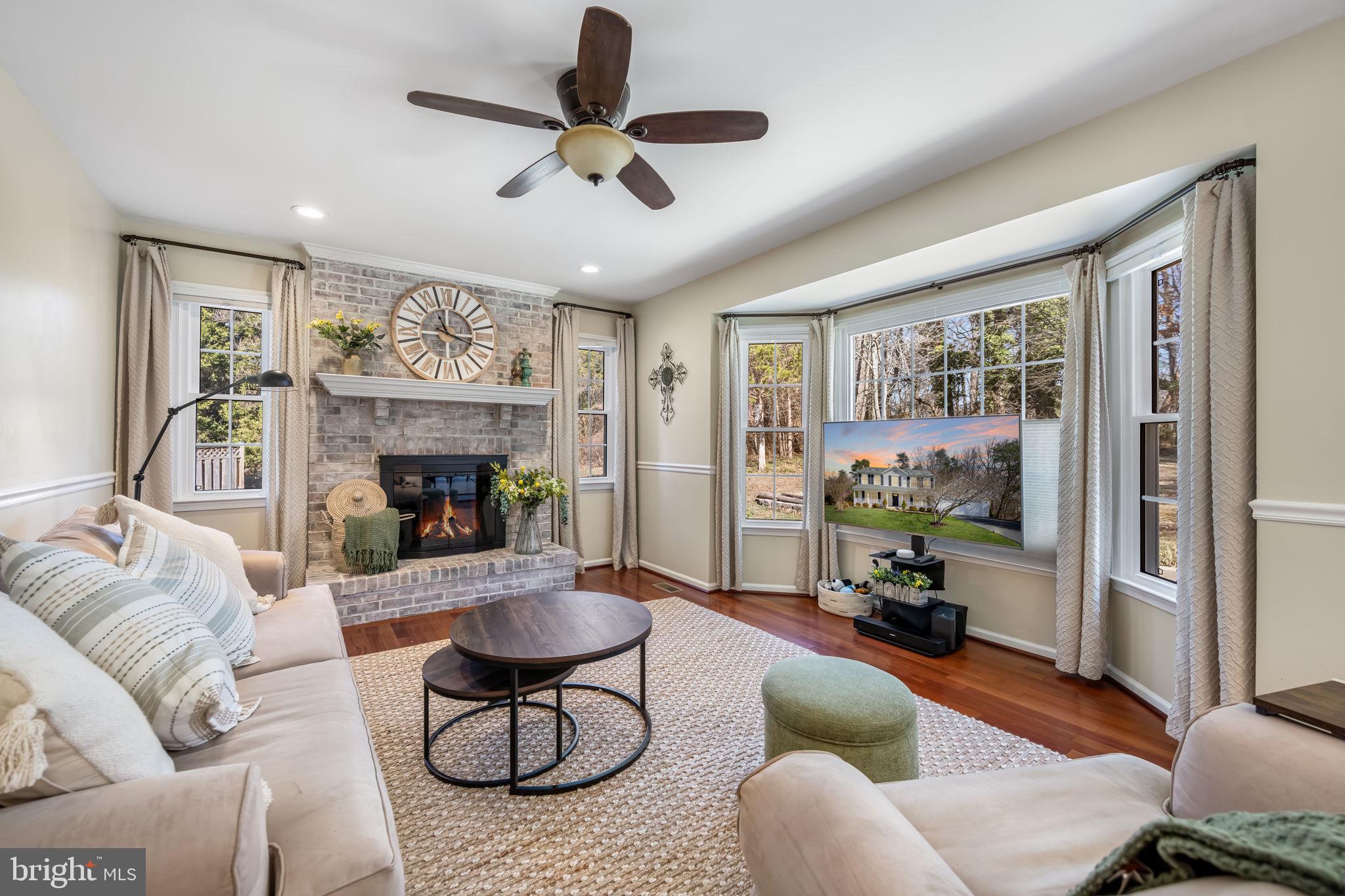 8504 Silverdale Road Lorton, VA 22079 - Photo 19 of 48 a living room with furniture a flat screen tv and a floor to ceiling window